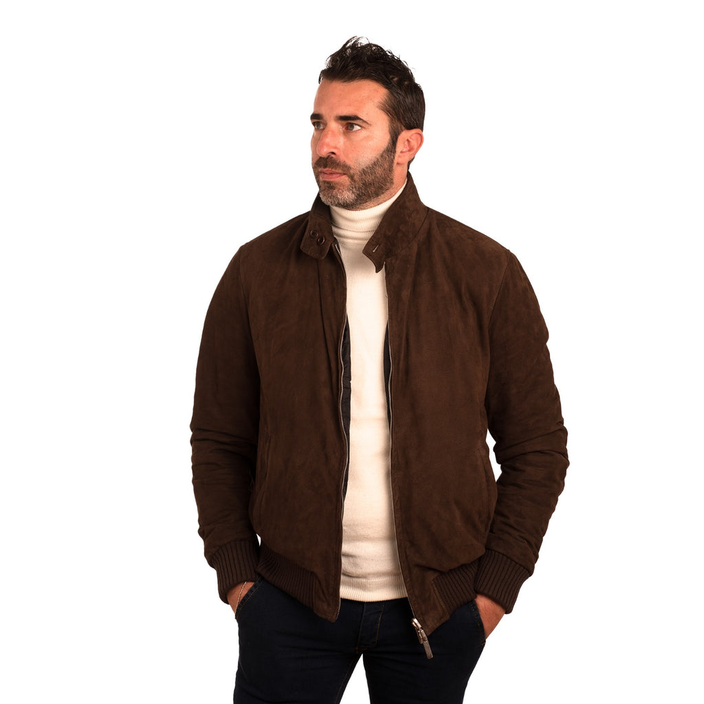 Men's brown suede bomber jacket with zipper, styled over cream turtleneck for modern casual wear