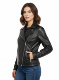 Woman wearing stylish black leather jacket with zipper details, paired with blue jeans for a trendy look.