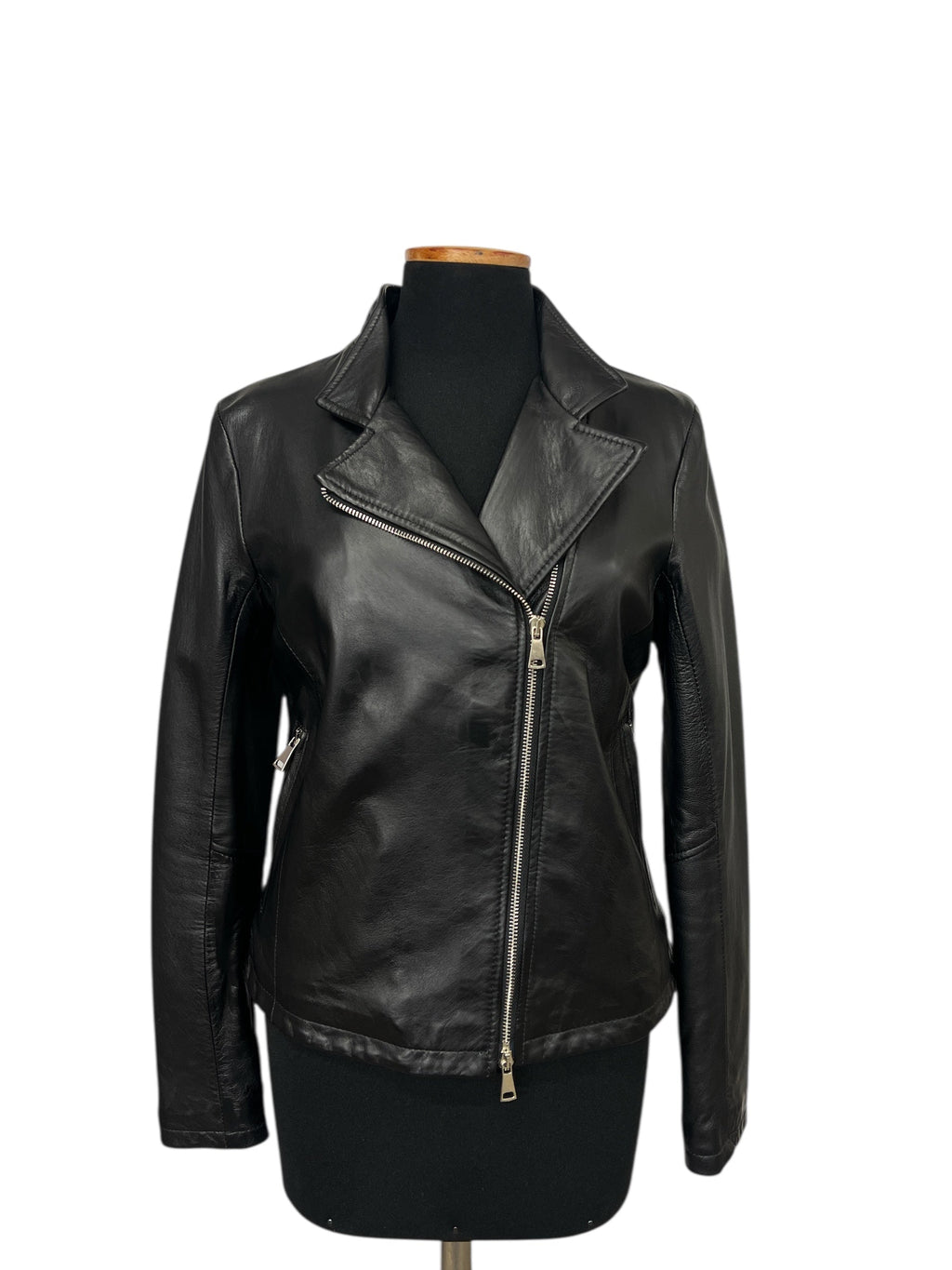 Black leather biker jacket with zipper front and lapels on mannequin