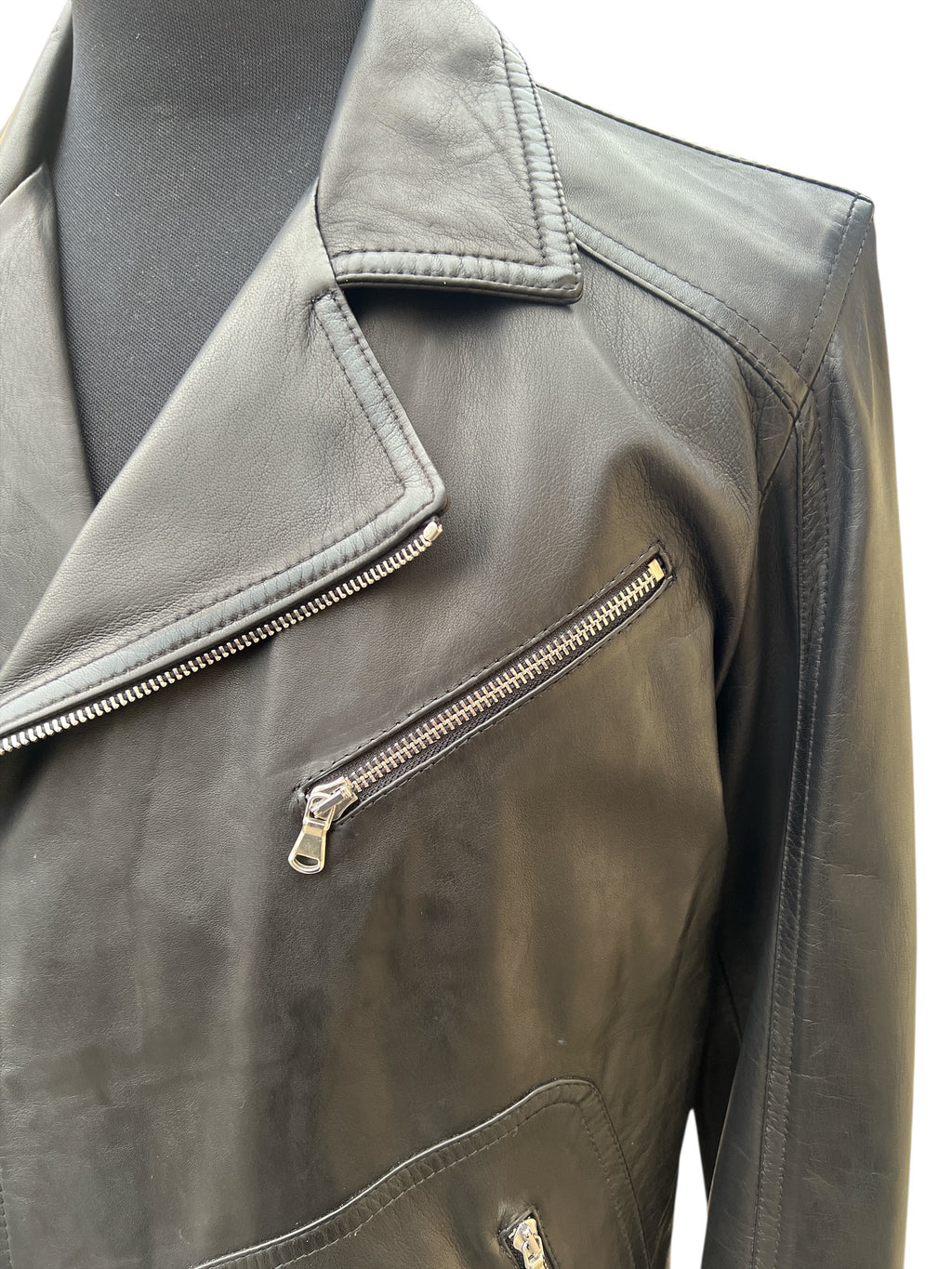 Black leather biker jacket with zippers and collar detail, stylish and durable fashion outerwear
