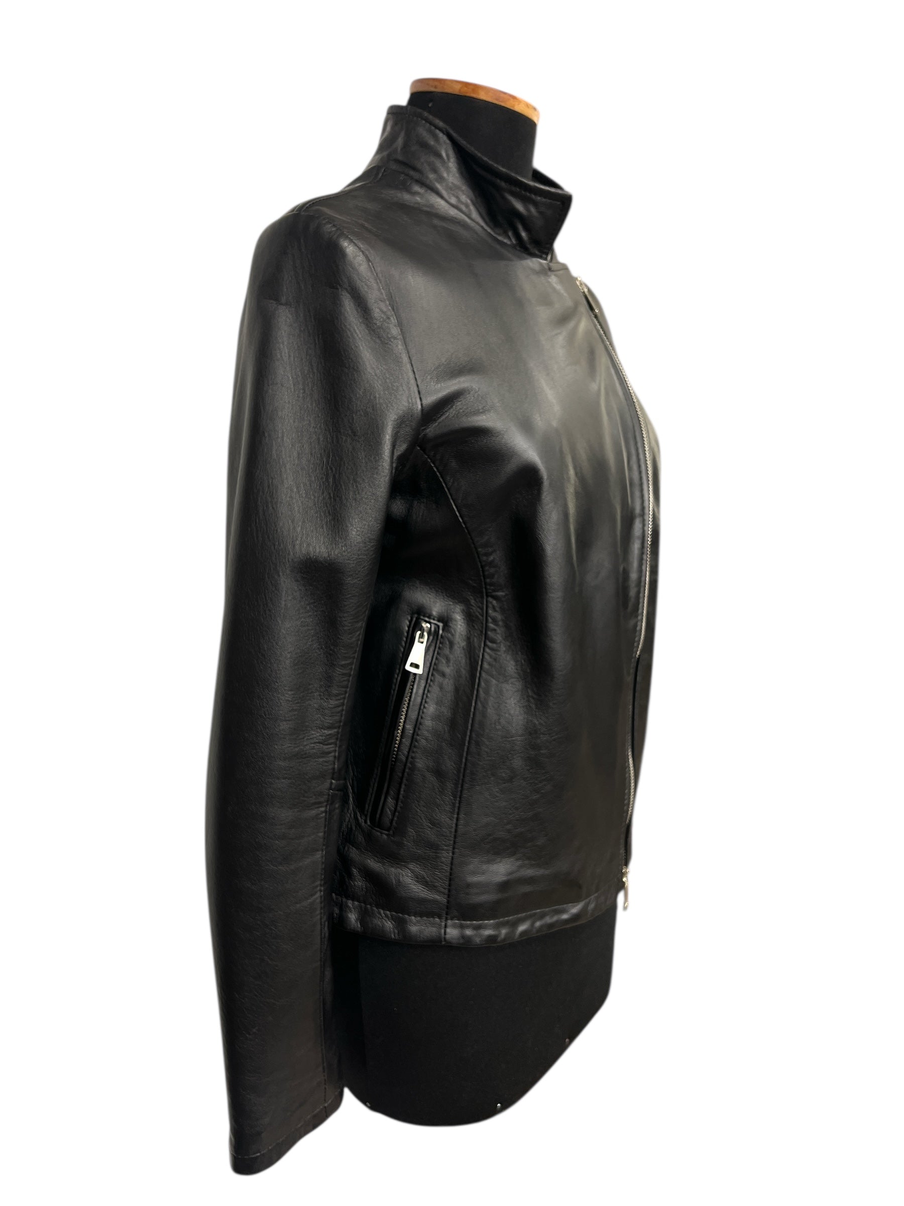 Black leather jacket with zipper closure and side pockets, styled on mannequin for modern fashion