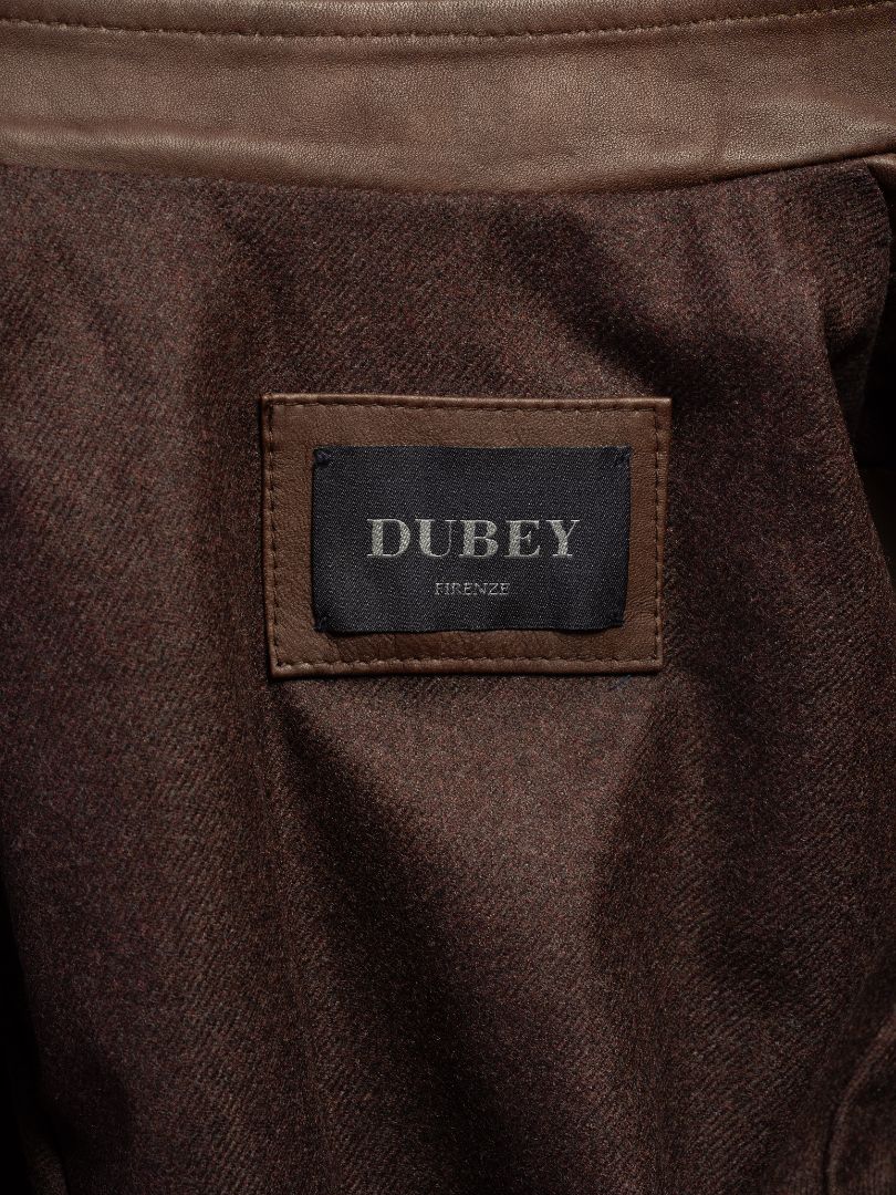 Dubey Firenze brand label on brown leather garment, showcasing premium fashion detail