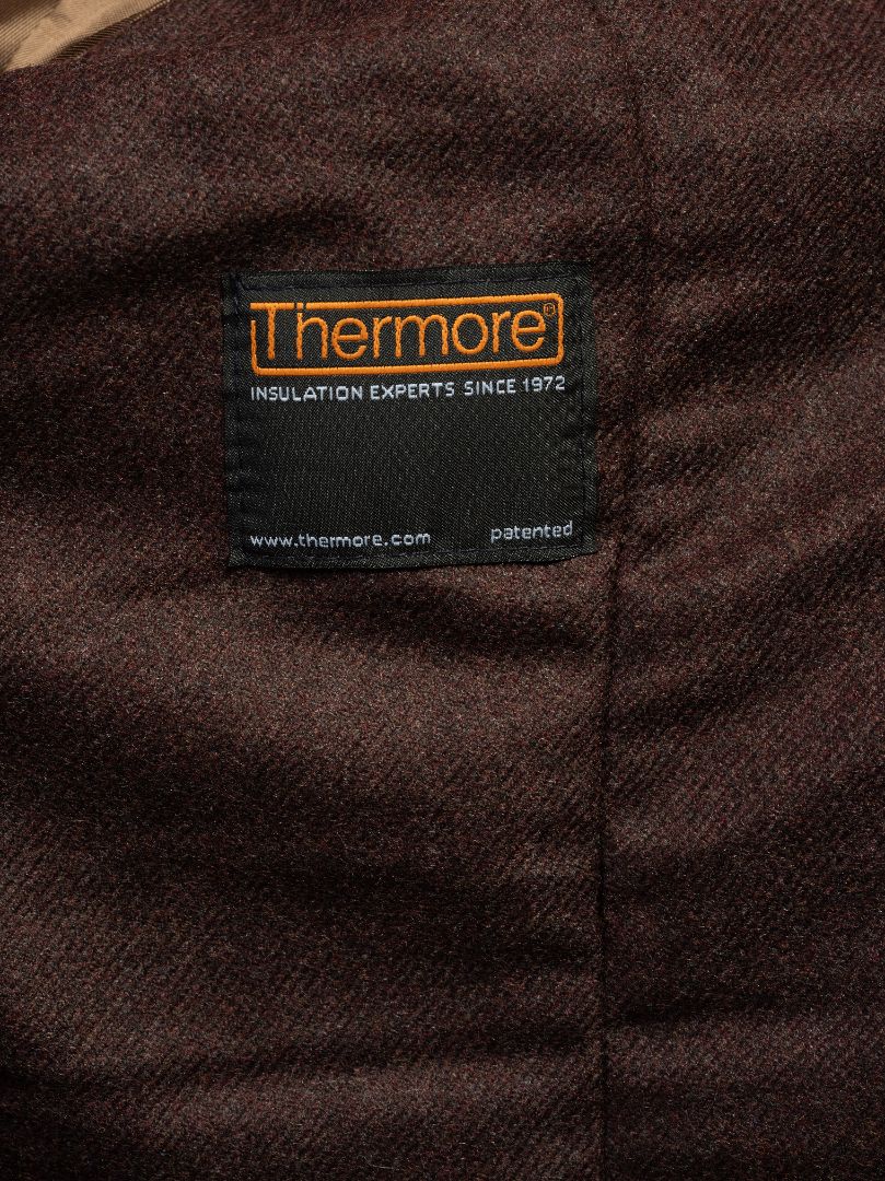 Thermore insulated lining label on dark brown textured fabric, patented warmth technology since 1972